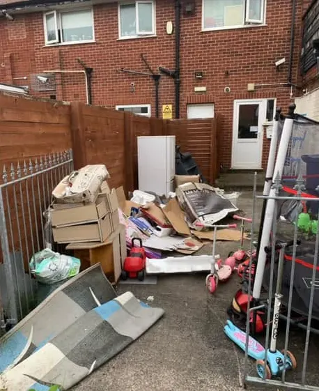 Before: cardboard boxes, a rug and rubbish piled in a terraced back yard