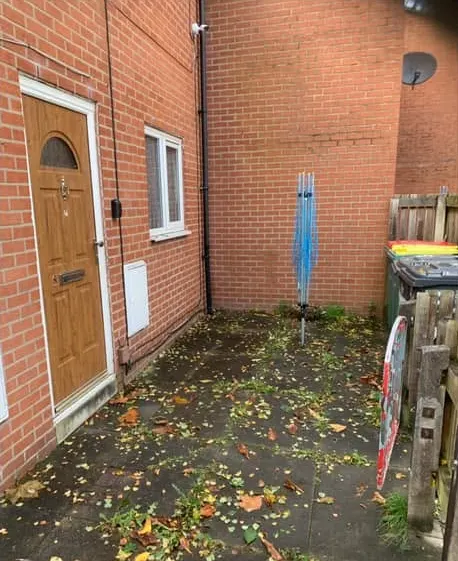 After: a clear courtyard outside a front door