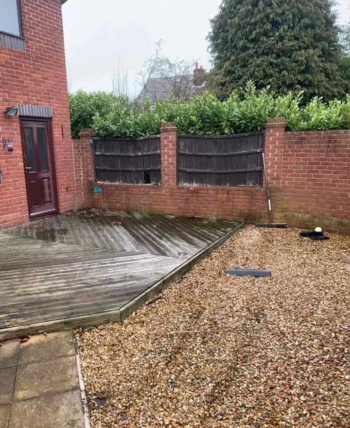 After: empty decking and gravel in a walled back garden