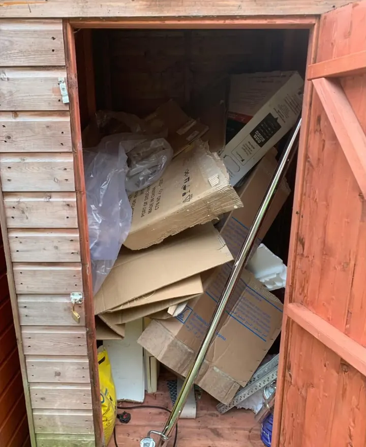 Before: a timber shed crammed with flattened boxes and packaging
